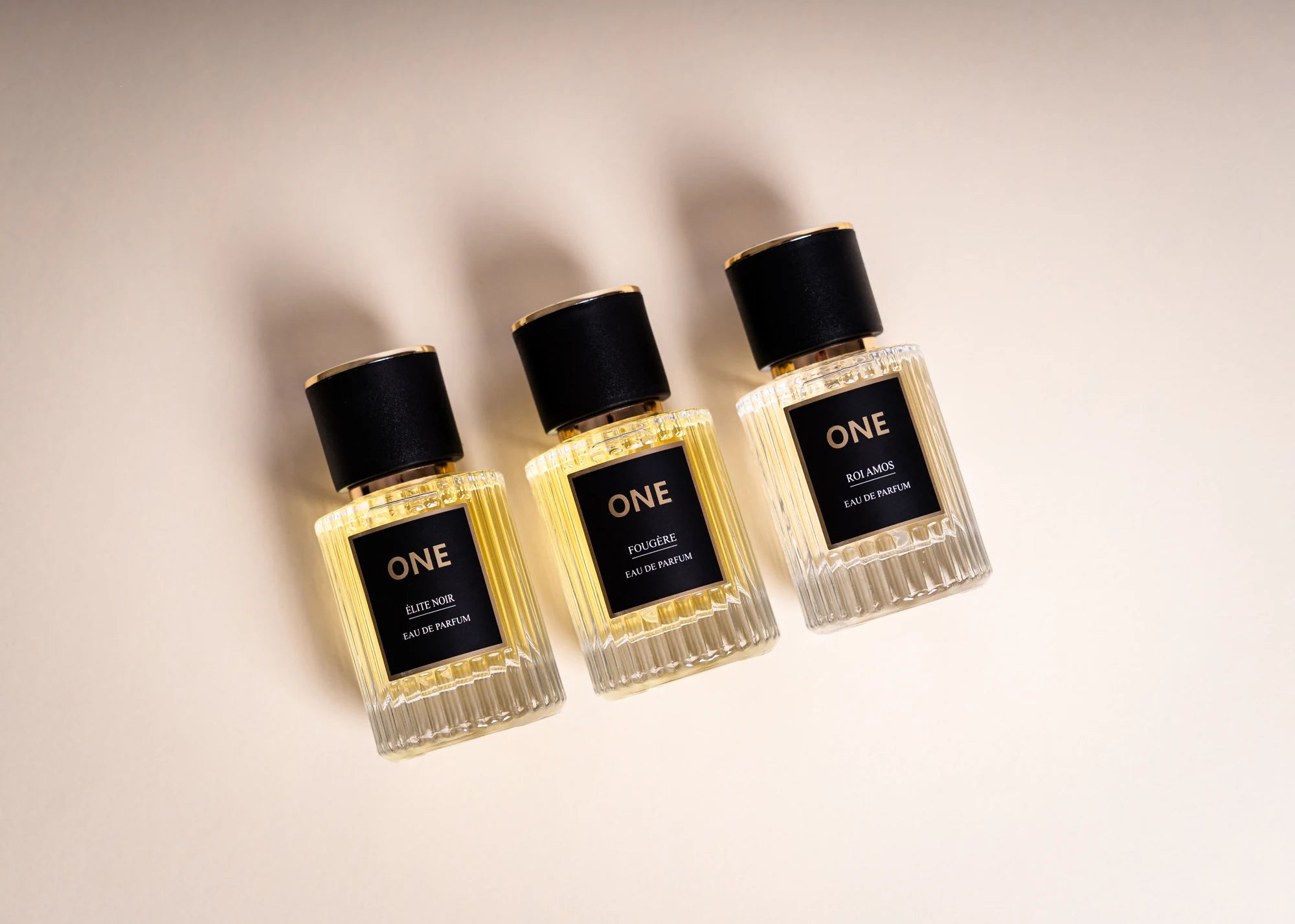 The original ONE Legacy Collection: Élite Noir, Fougère and Roi Amos in ribbed glass bottles with black and gold labels