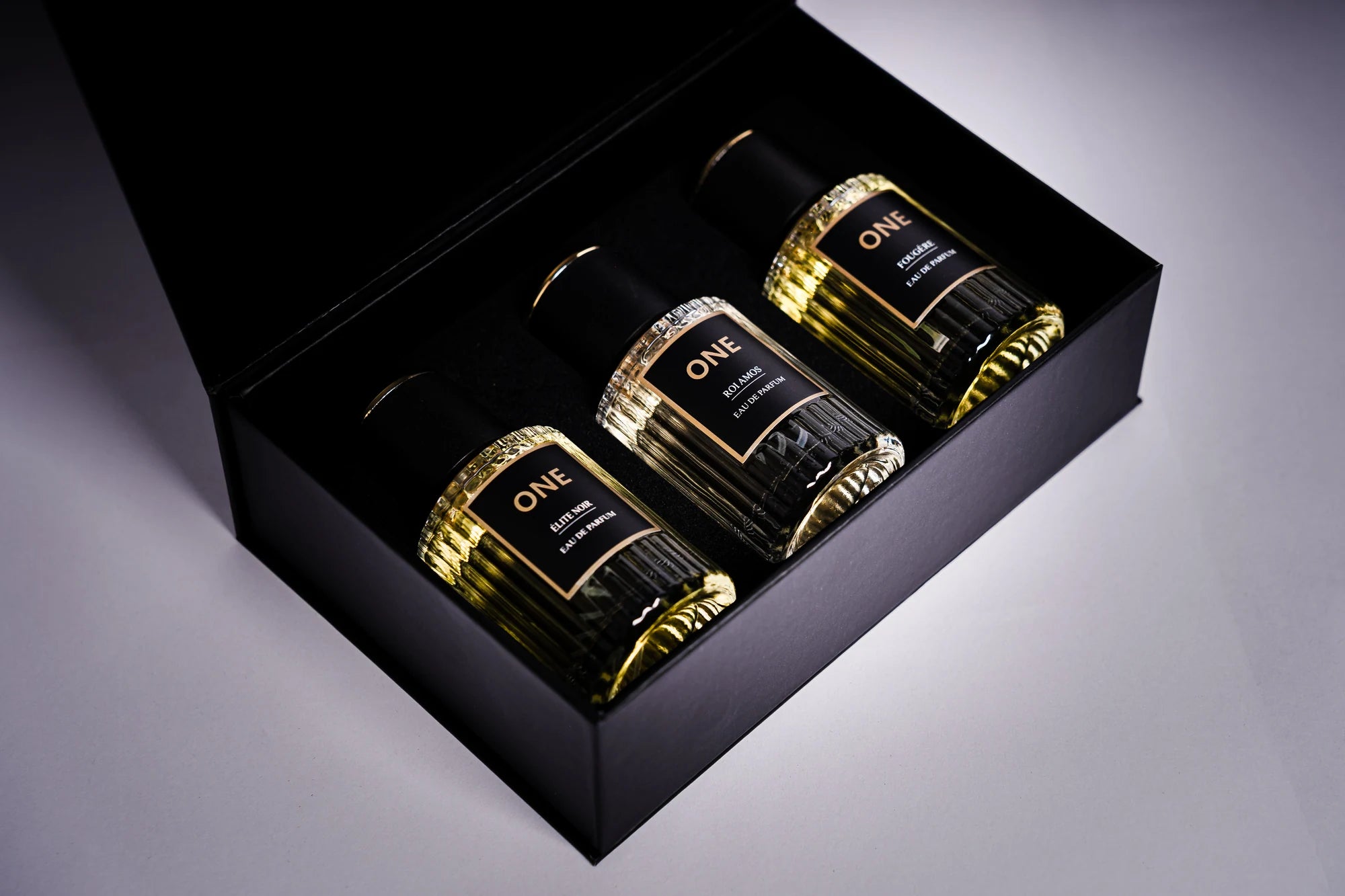 Original ONE Legacy Collection bottles of Élite Noir, Roi Amos and Fougère in their black presentation box