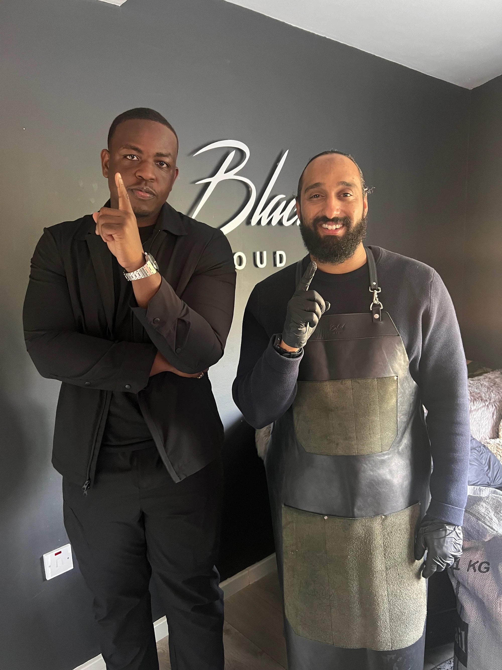 Shawn Pettieway and his mentor, Walid, at Black Oud London, both raising one finger