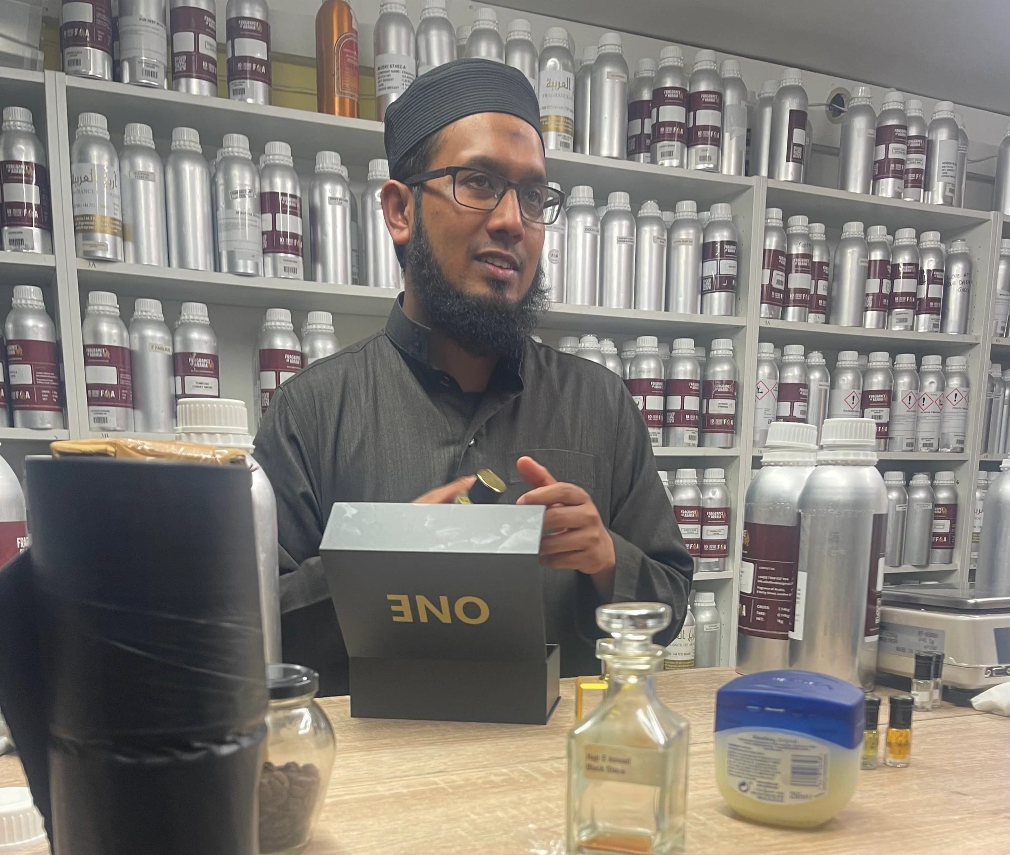 The independent master perfumer working with ONE at his workbench in London, with an original ONE presentation box