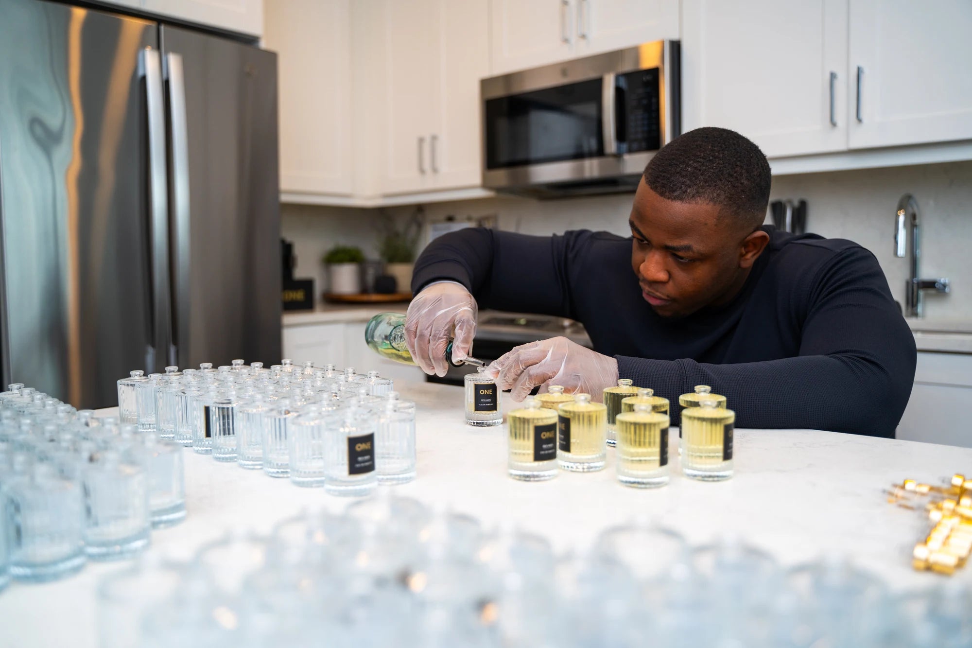 Shawn Pettieway at work, carefully pouring fragrance into an original ONE bottle